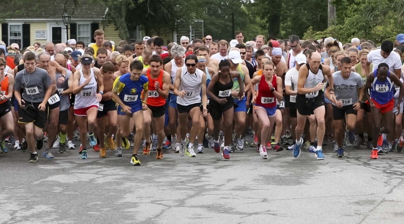 Runners take off from the starting line for the Little Compton Road Race at the United Congregational Church Fair in Little Compton, Saturday. Photo by Bill Murphy.